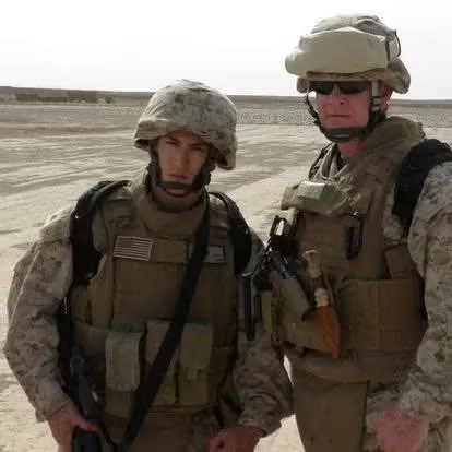 Patrick, left, in desert combat gear with a fellow Marine in Afghanistan