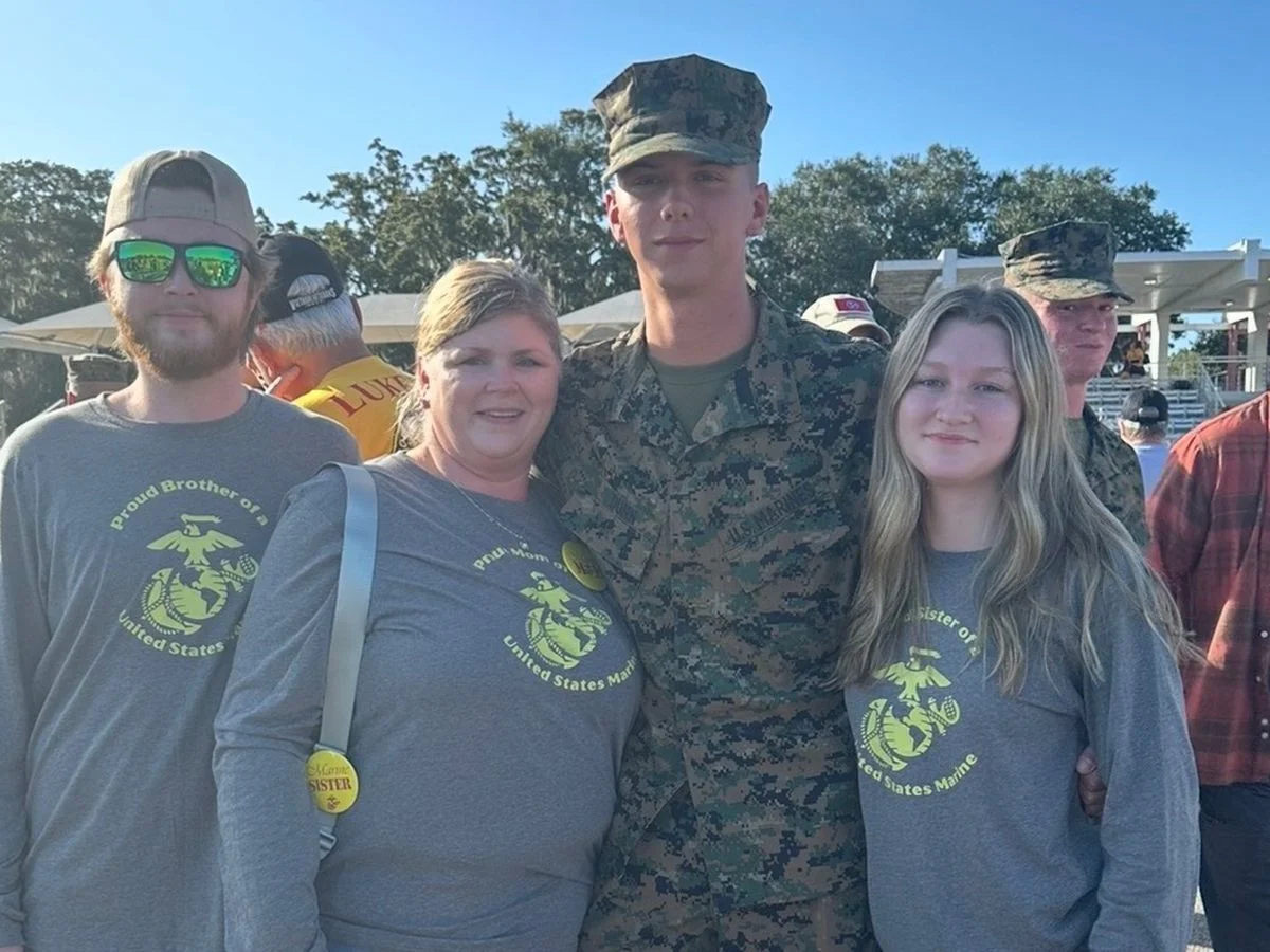 LCpl Landon Dunn in uniform with his family at his Marine Corps graduation